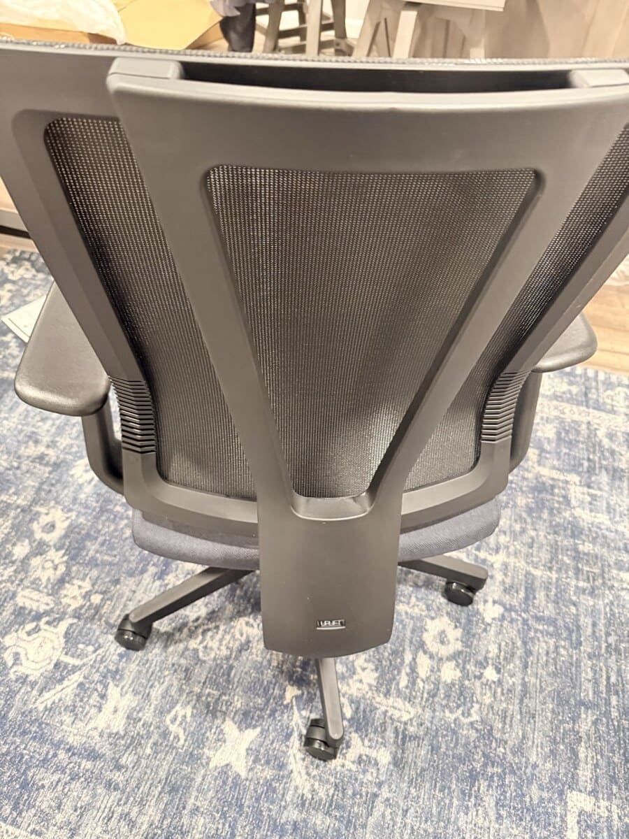UPLIFT Clarksville mesh back close-up showing adaptive lumbar frame and UPLIFT Desk branding