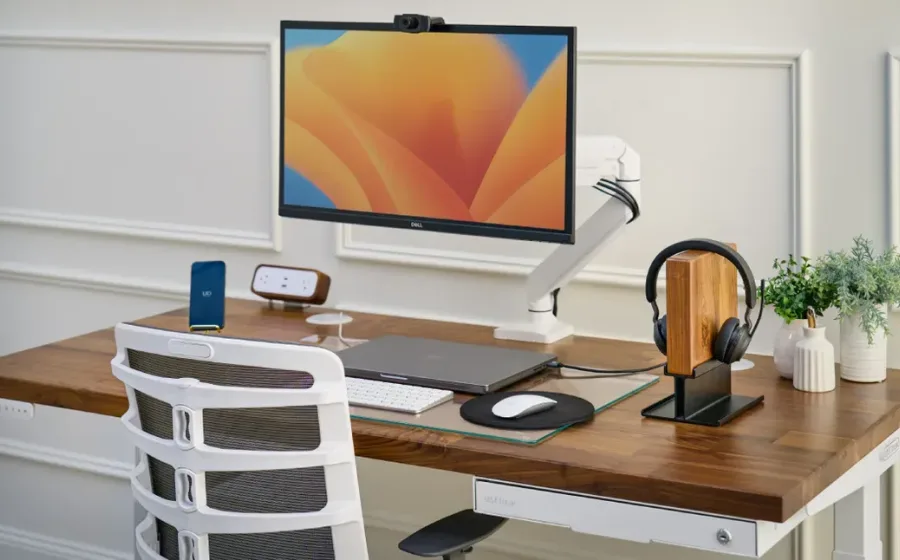UPLIFT V3 Standing Desk in walnut with a clean cable path