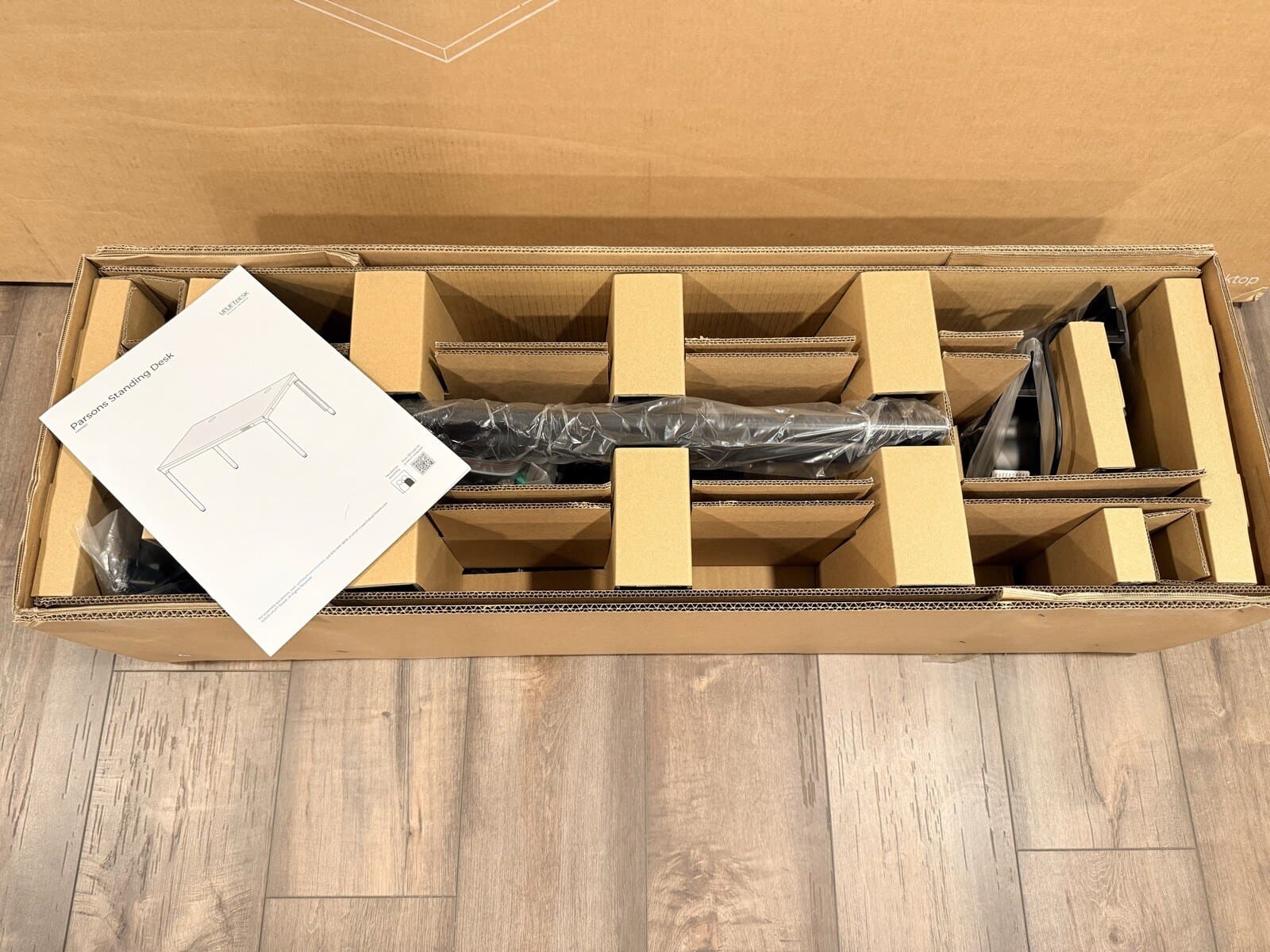 Parsons frame box opened with manual and all parts nested inside