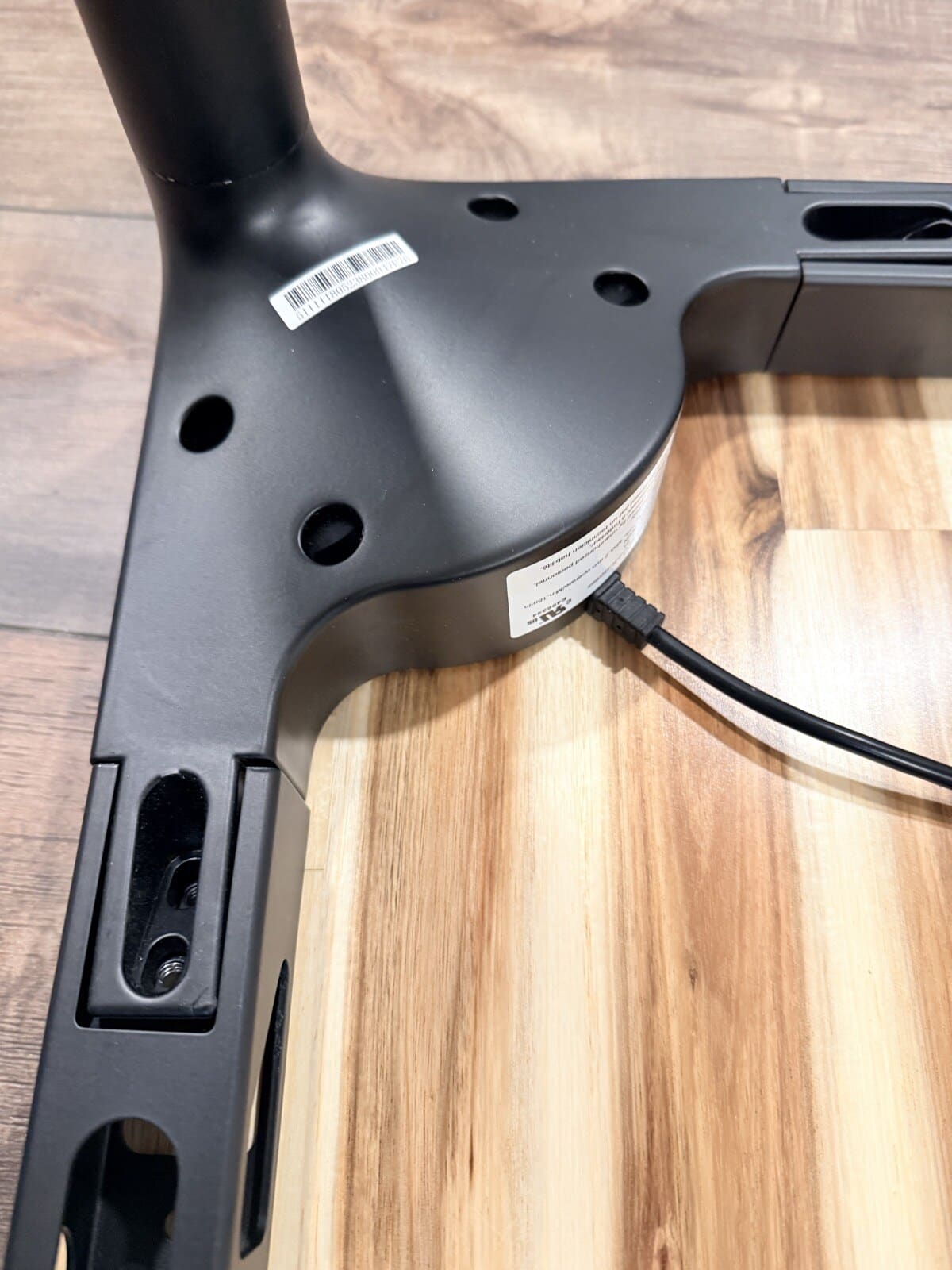 Leg bracket mounted to frame showing cable routing