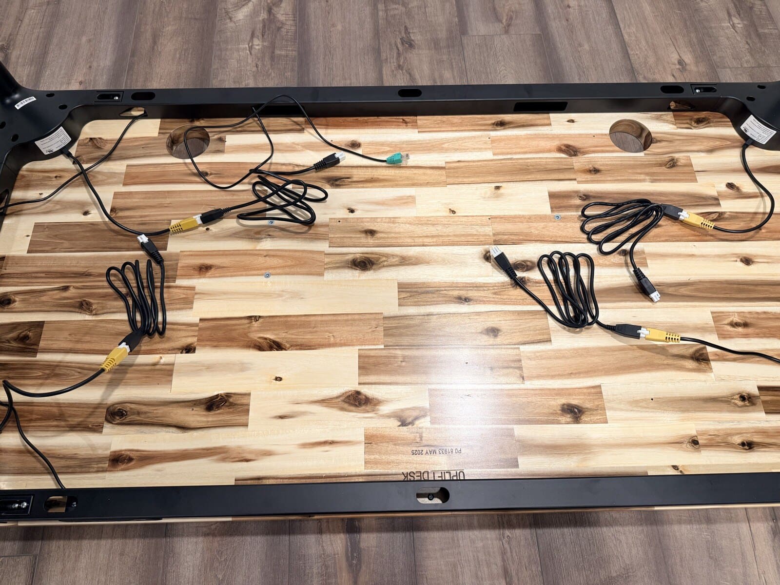 Full underside view with all cables connected before flipping the desk