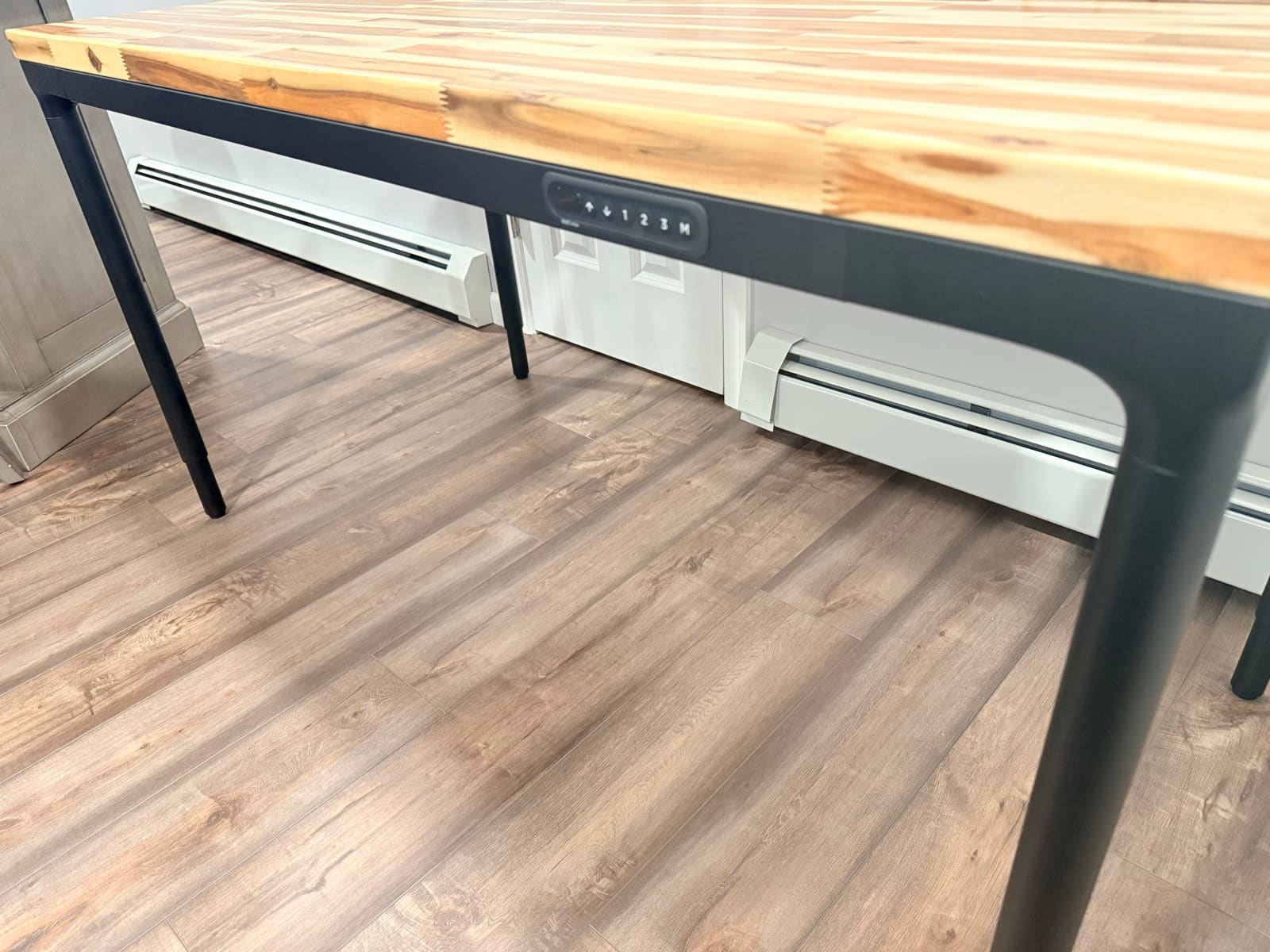 The assembled UPLIFT Parsons Standing Desk with Acacia Butcher Block desktop