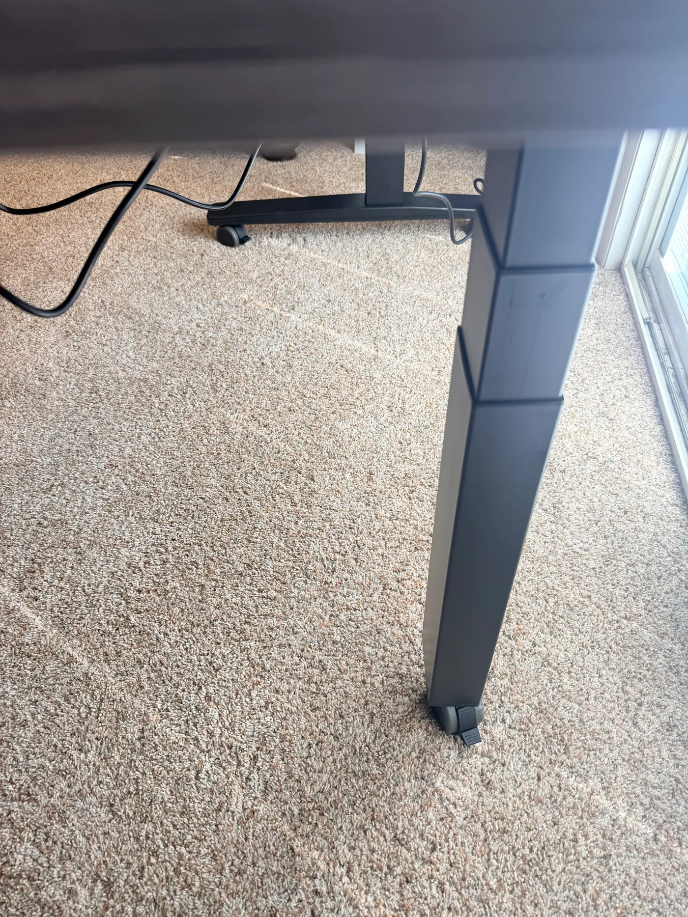 UPLIFT FlexMount Cable Manager pre-installed on the V3 frame's control box crossbar, with the desk power cable routed through the patent-pending tray for tool-free cable management