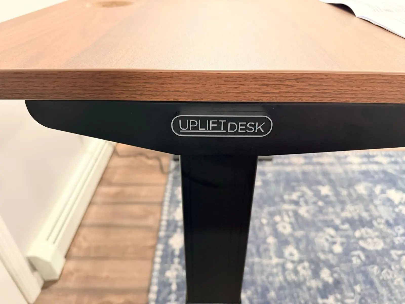 UPLIFT DESK logo badge on the frame