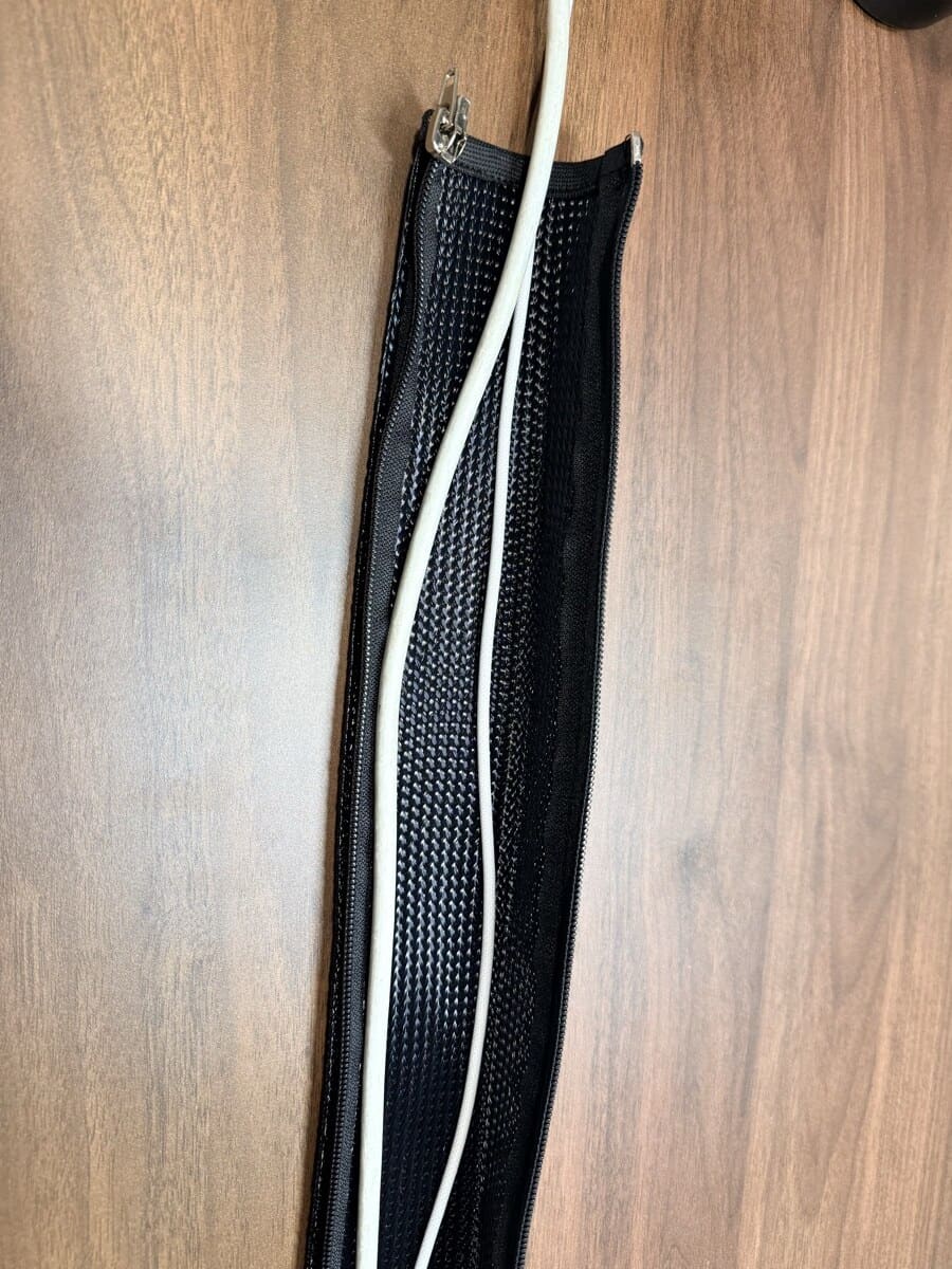 UPLIFT cable sleeve zipper open showing cables routed inside